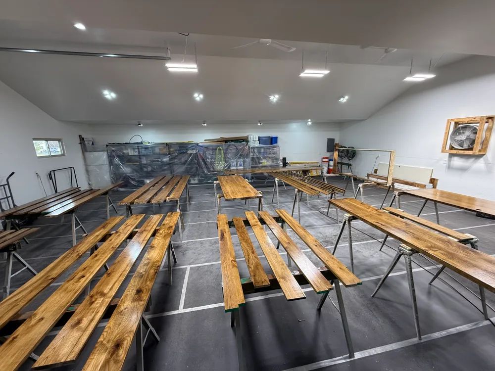 A large room filled with wooden benches and tables.