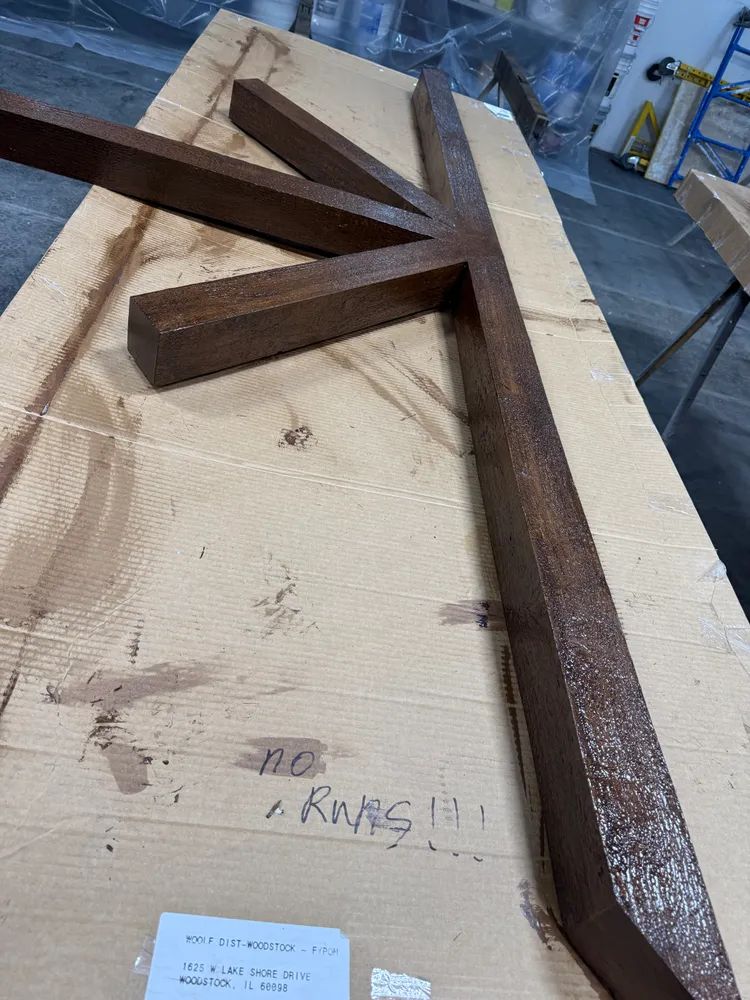 A wooden cross is sitting on top of a cardboard box.