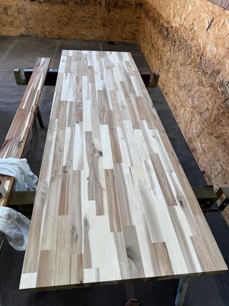 A wooden picnic table with two benches in a room.