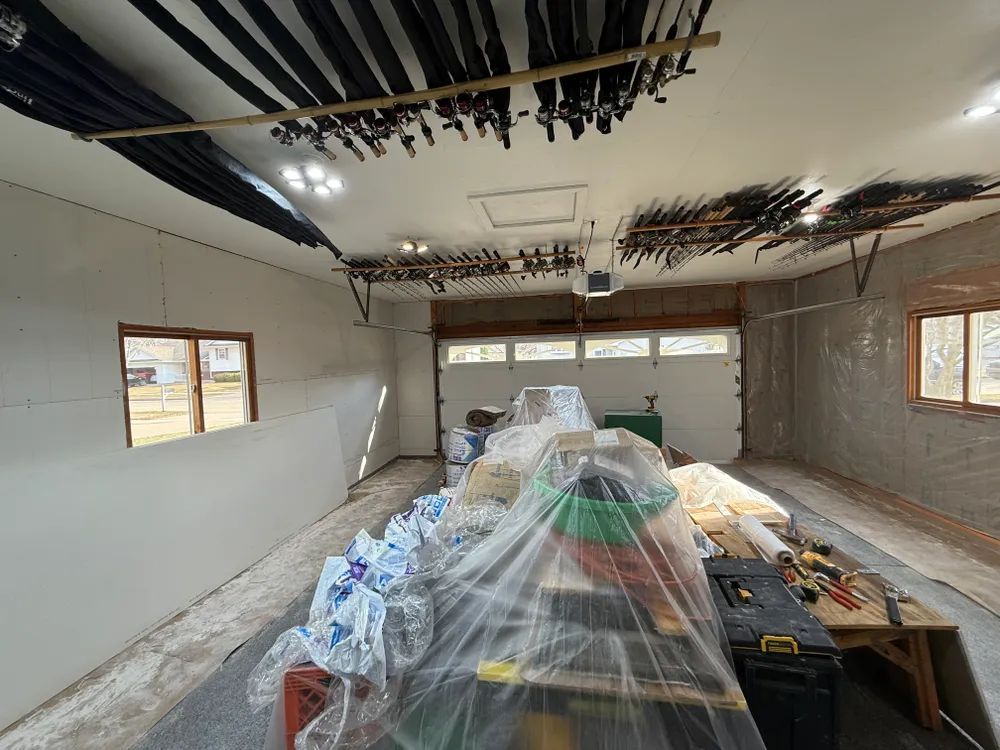 A garage with a ladder and a table in it.