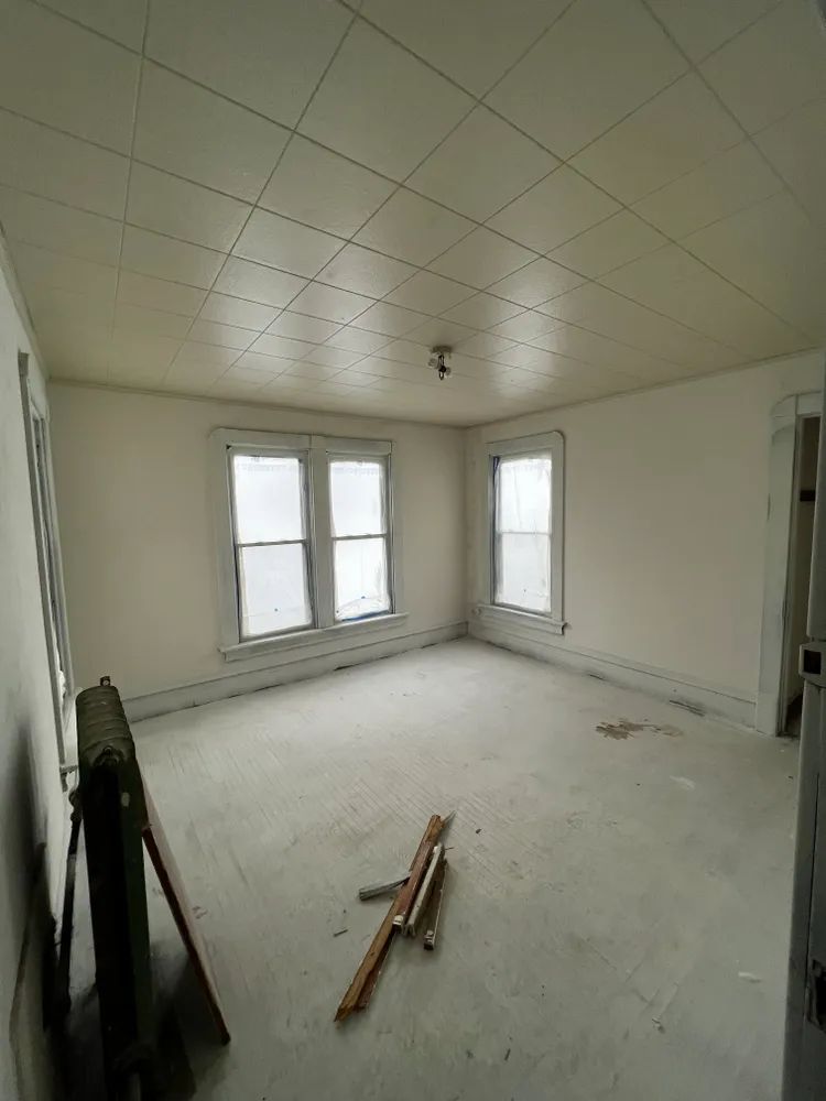 A large empty room with white walls and a white ceiling.