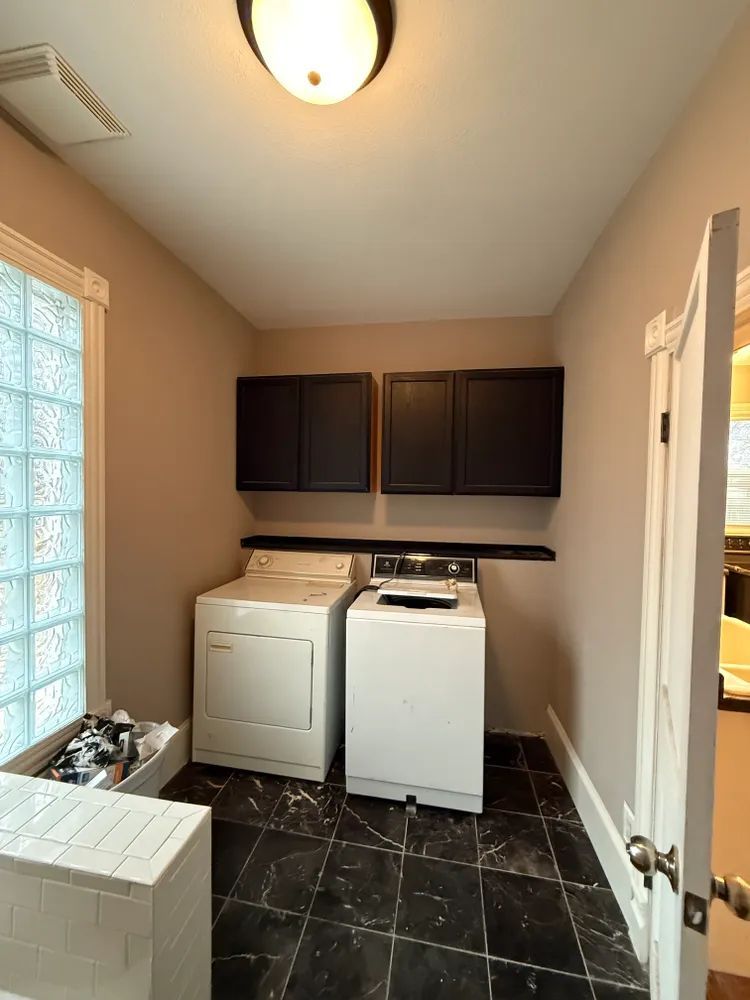 A laundry room with a washer and dryer in it