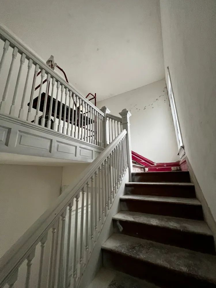 A staircase with a white railing and wooden steps