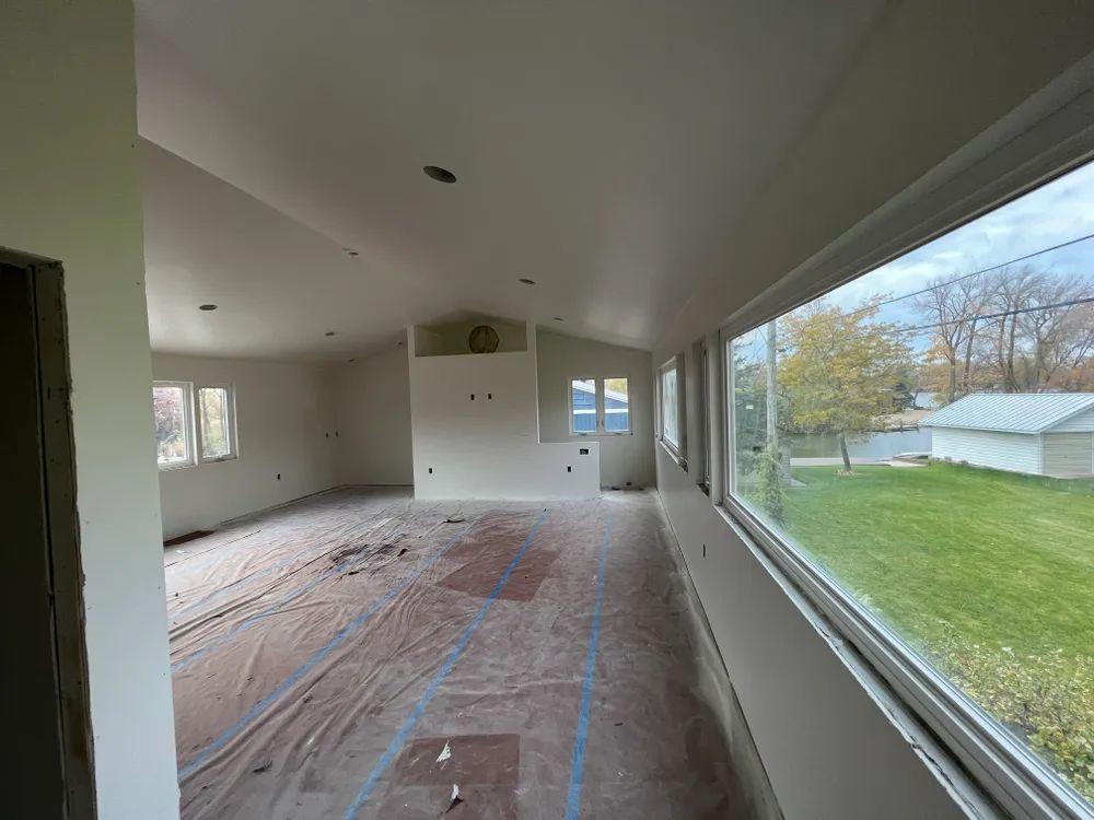 A large room with a lot of windows and a lot of white walls.