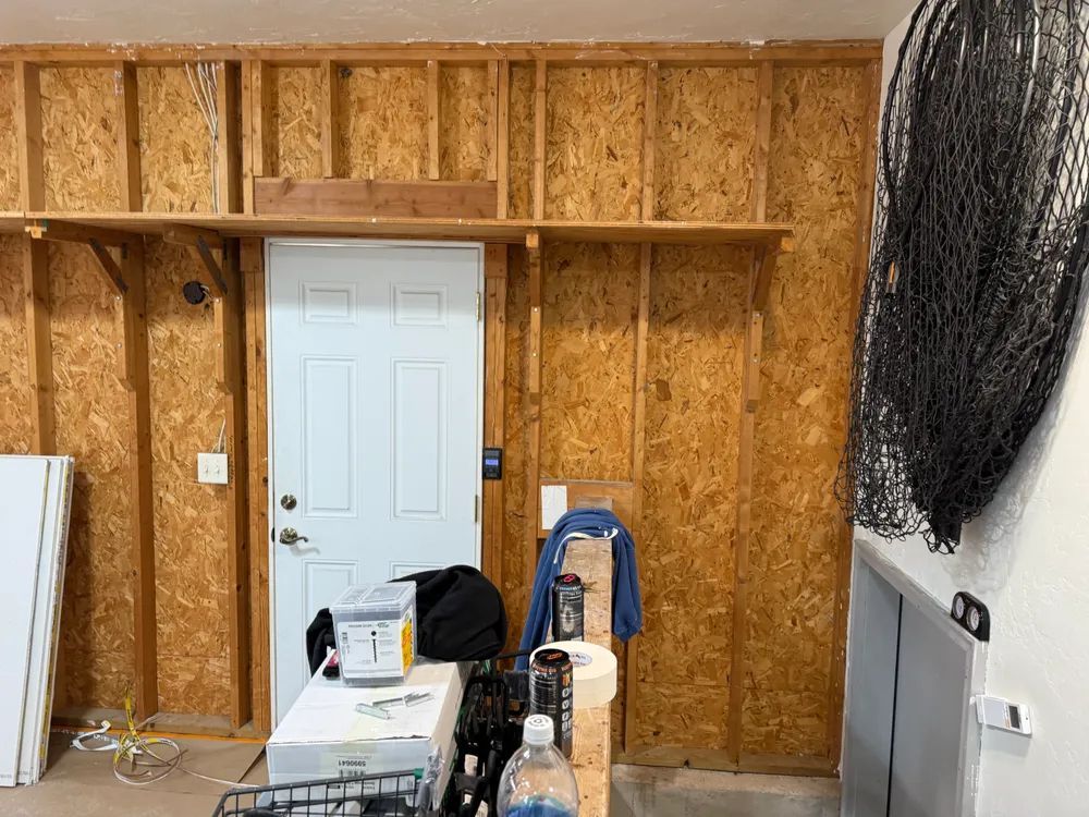 A garage with wooden walls and a white door.