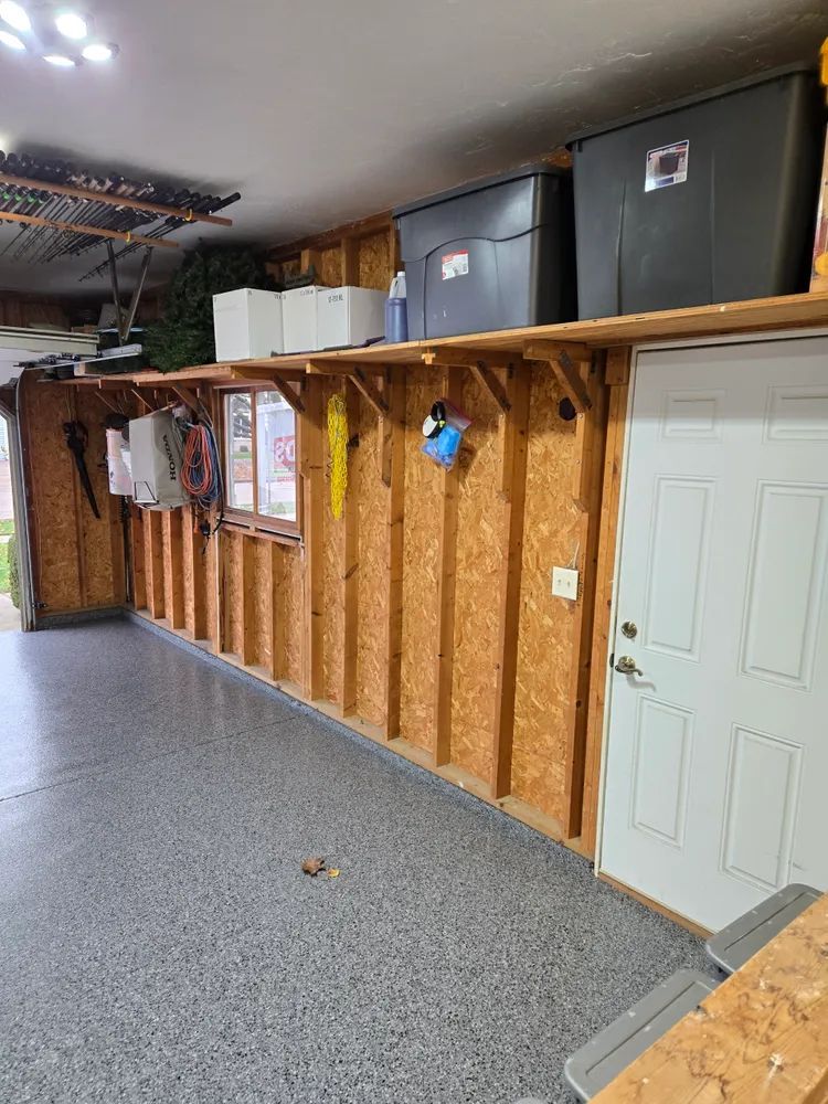 A garage with a lot of shelves and a door.