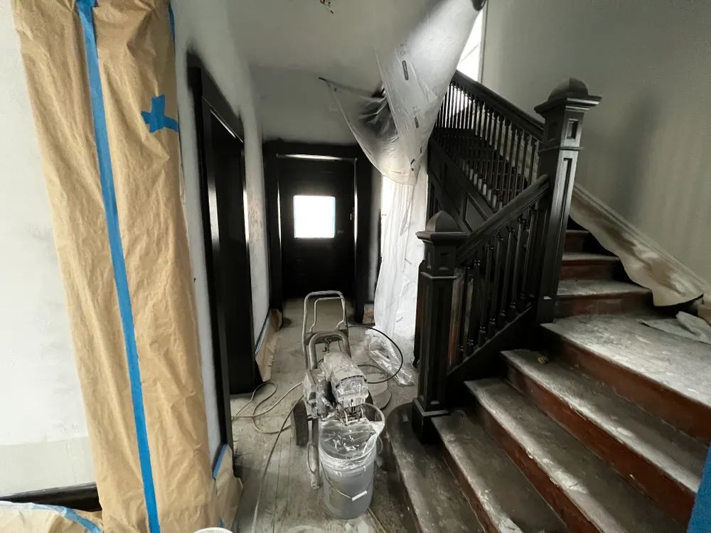 A staircase is being painted in a house