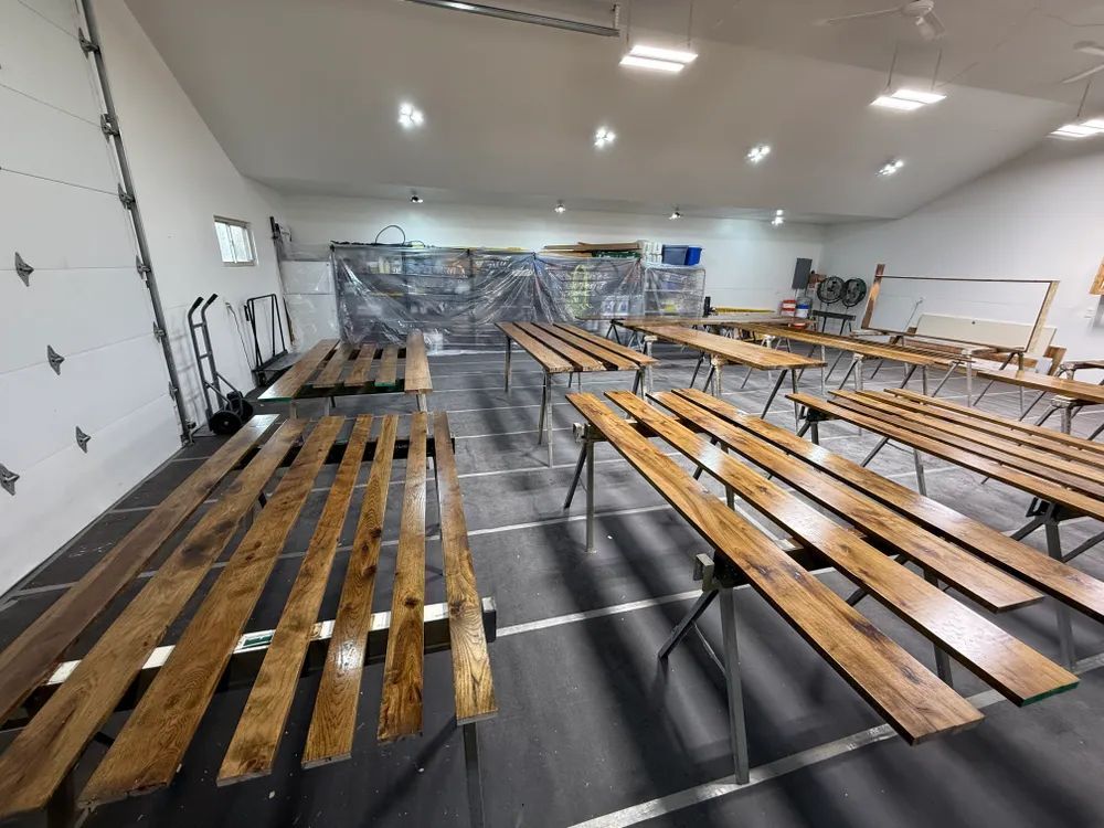 A large room filled with wooden benches and tables