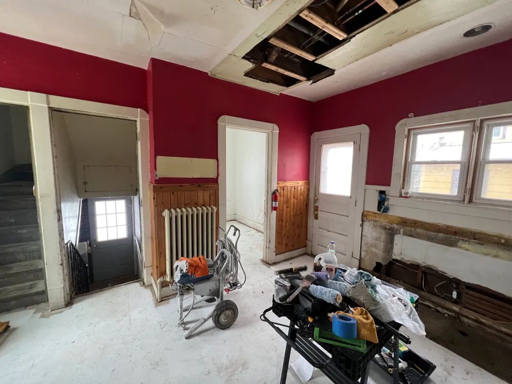 A room with red walls and a table with tools on it.