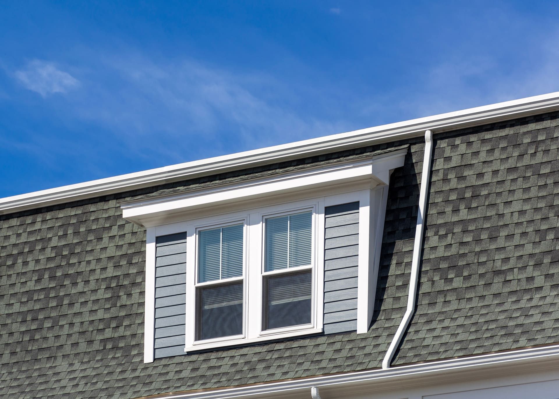 close-up view of the upper portion of a residential building with dormer in Brighton, Massachusetts, USA