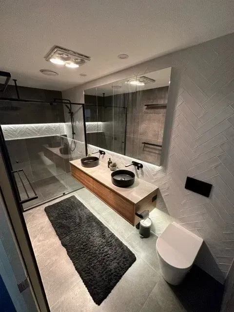 Modern Bathroom With Grey and Wood Tones, Features a Double Vanity, Shower, and Toilet — Precise Plumbing & Drainage In Conder, ACT