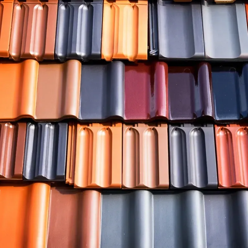 A bunch of different colored roof tiles are stacked on top of each other