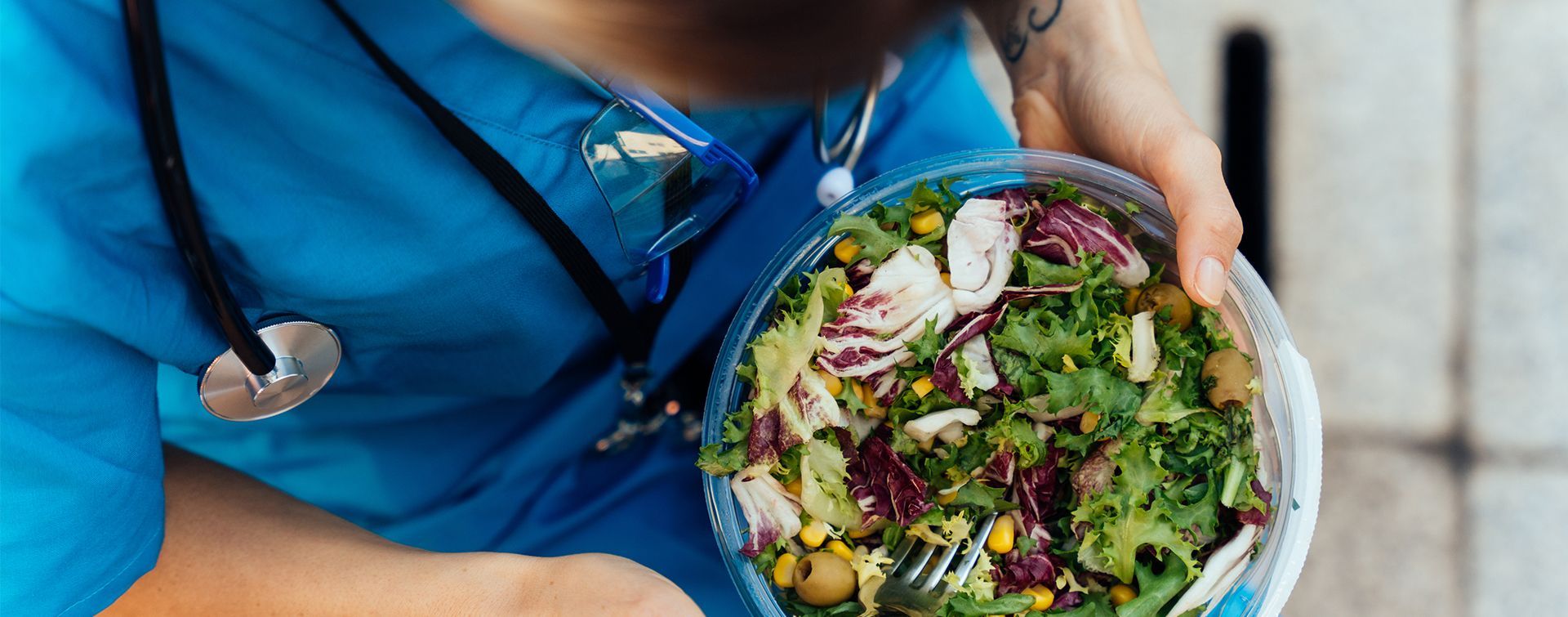 Healthcare worker eating a salad