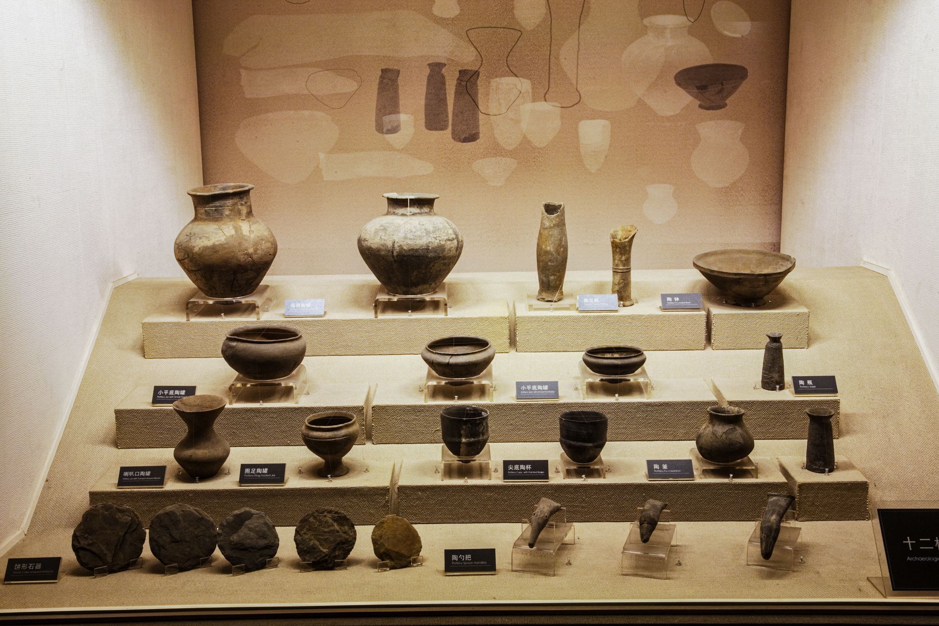 A display case filled with a variety of ancient artifacts