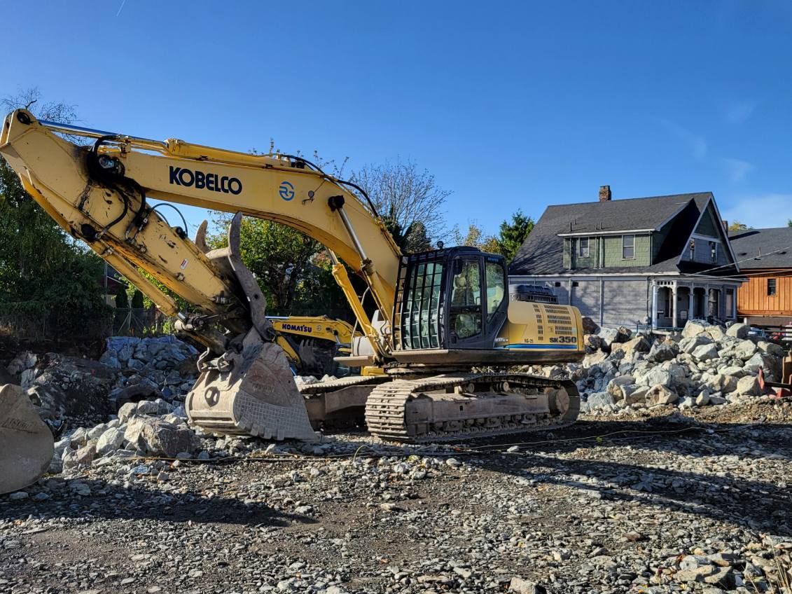 excavator clearing parcel of land
