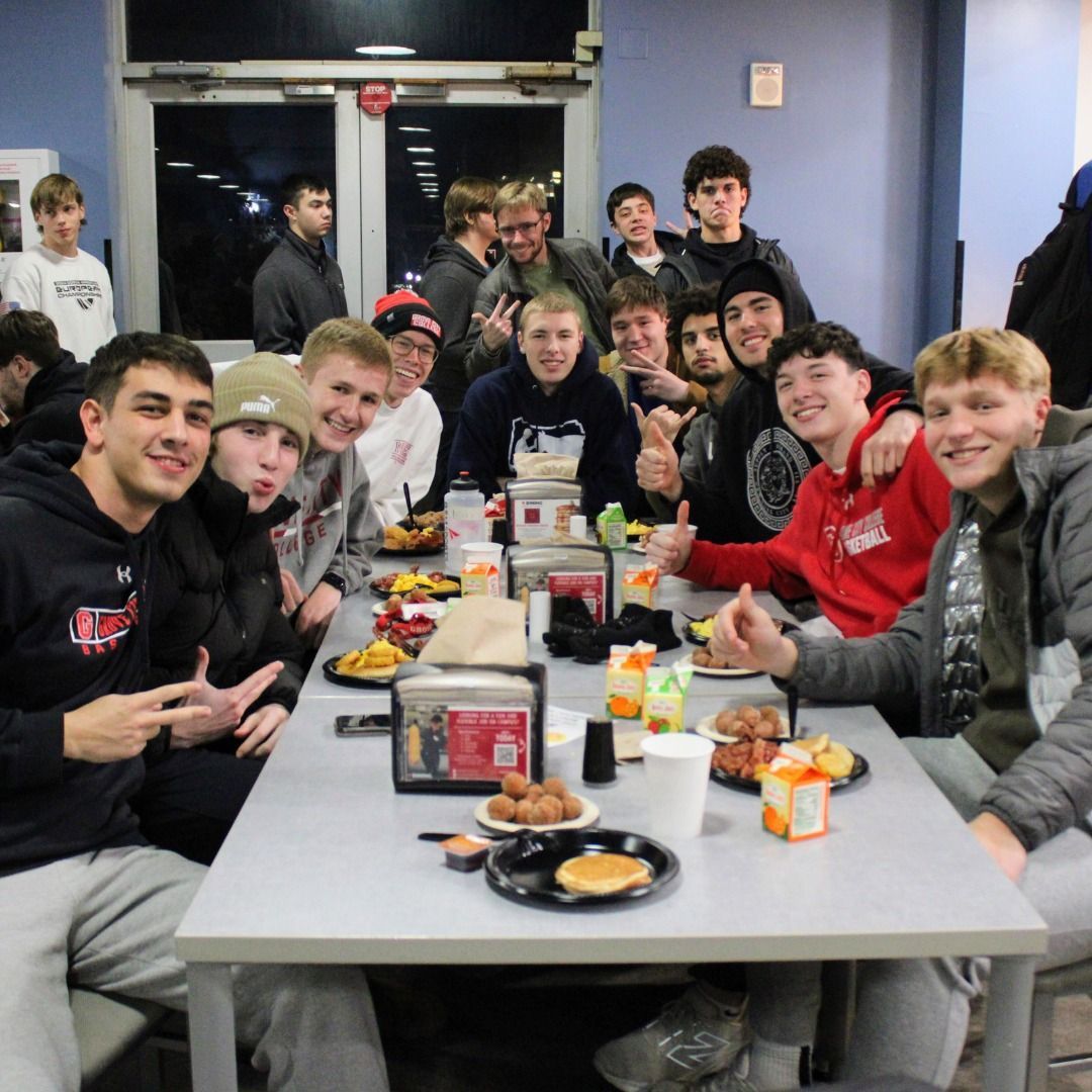 A man in a chef 's hat is posing for a picture with two other chefs