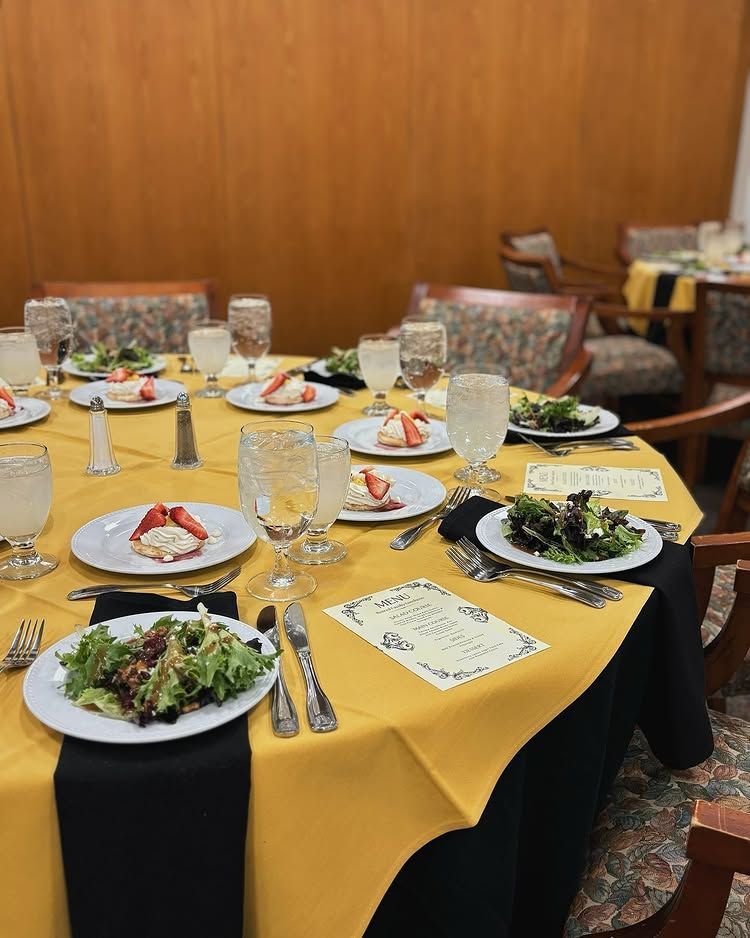 A table set with plates of food and glasses of water