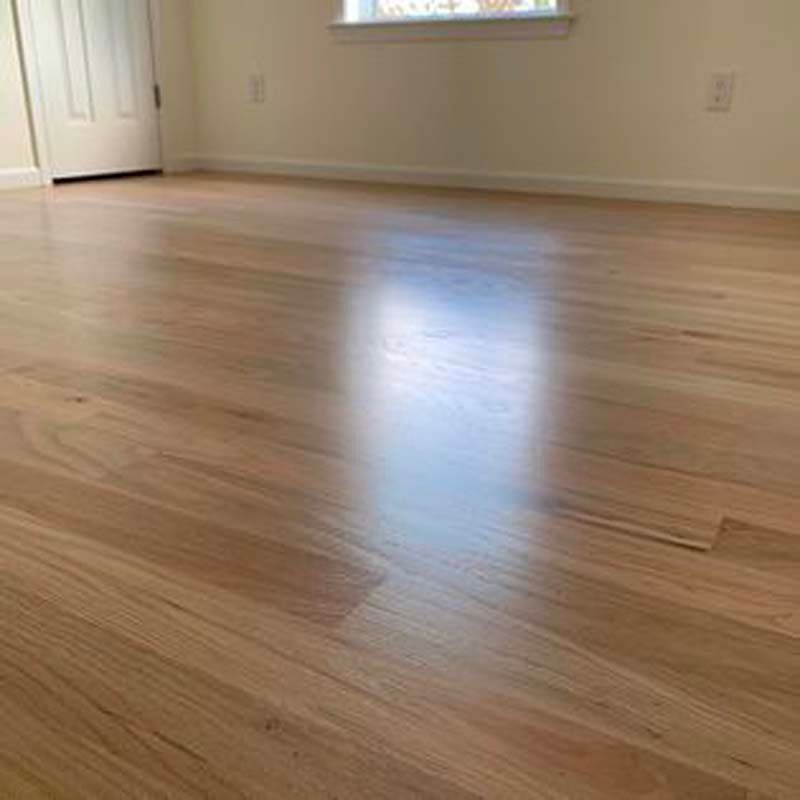 A room with a wooden floor and white walls.