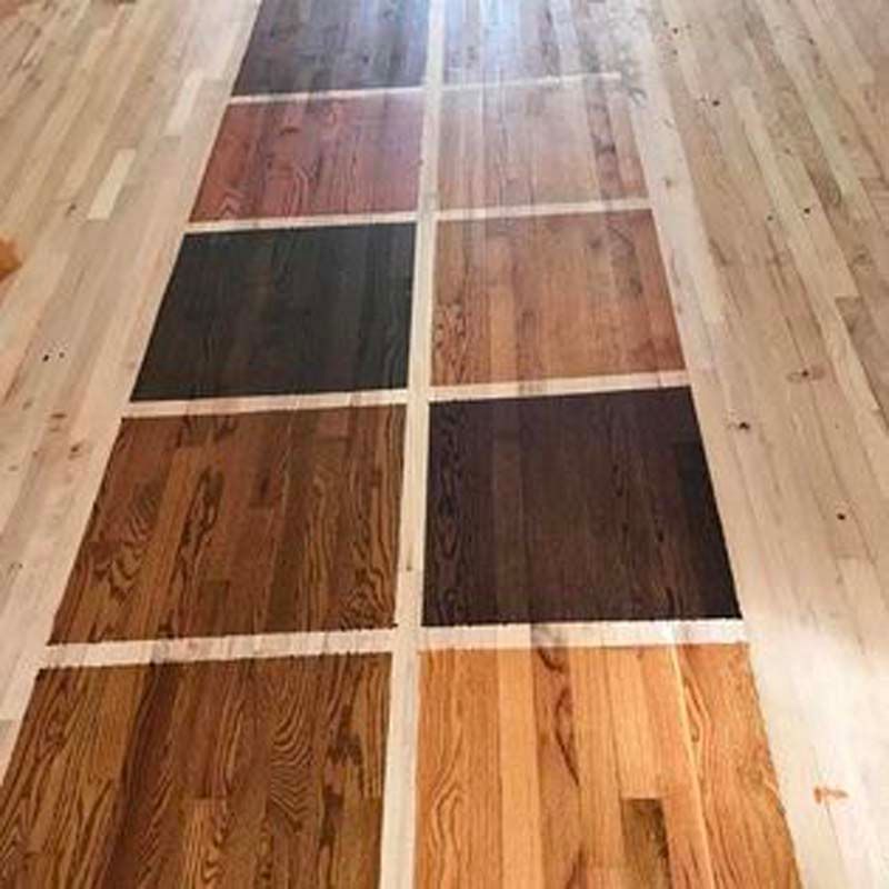 A wooden floor with different shades of wood.