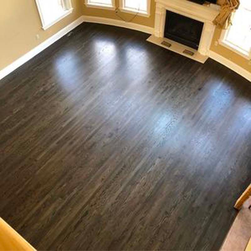 A living room with hardwood floors and a fireplace.