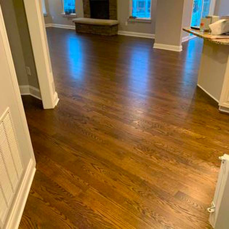 A living room with hardwood floors and a fireplace.
