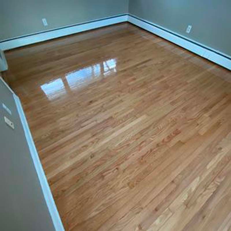 A room with hardwood floors and a white trim.