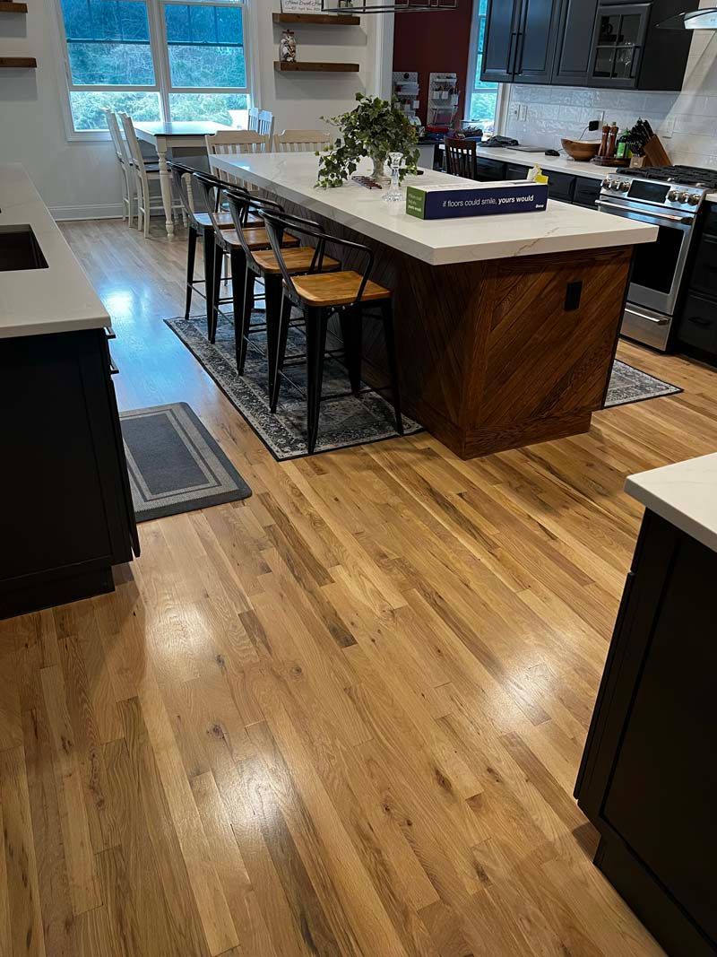 A kitchen with hardwood floors and a large island.