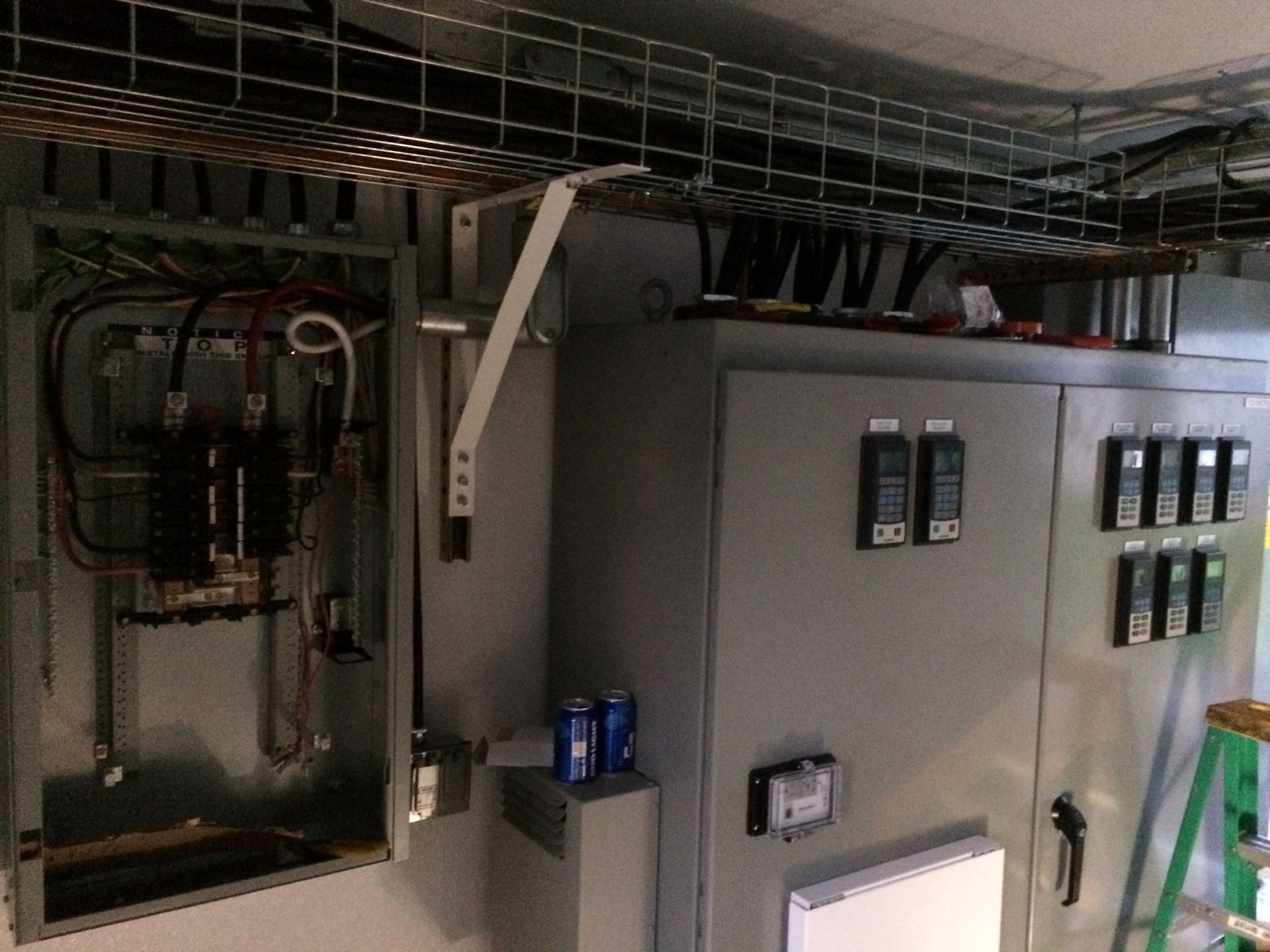A large electrical box with a ladder in the background