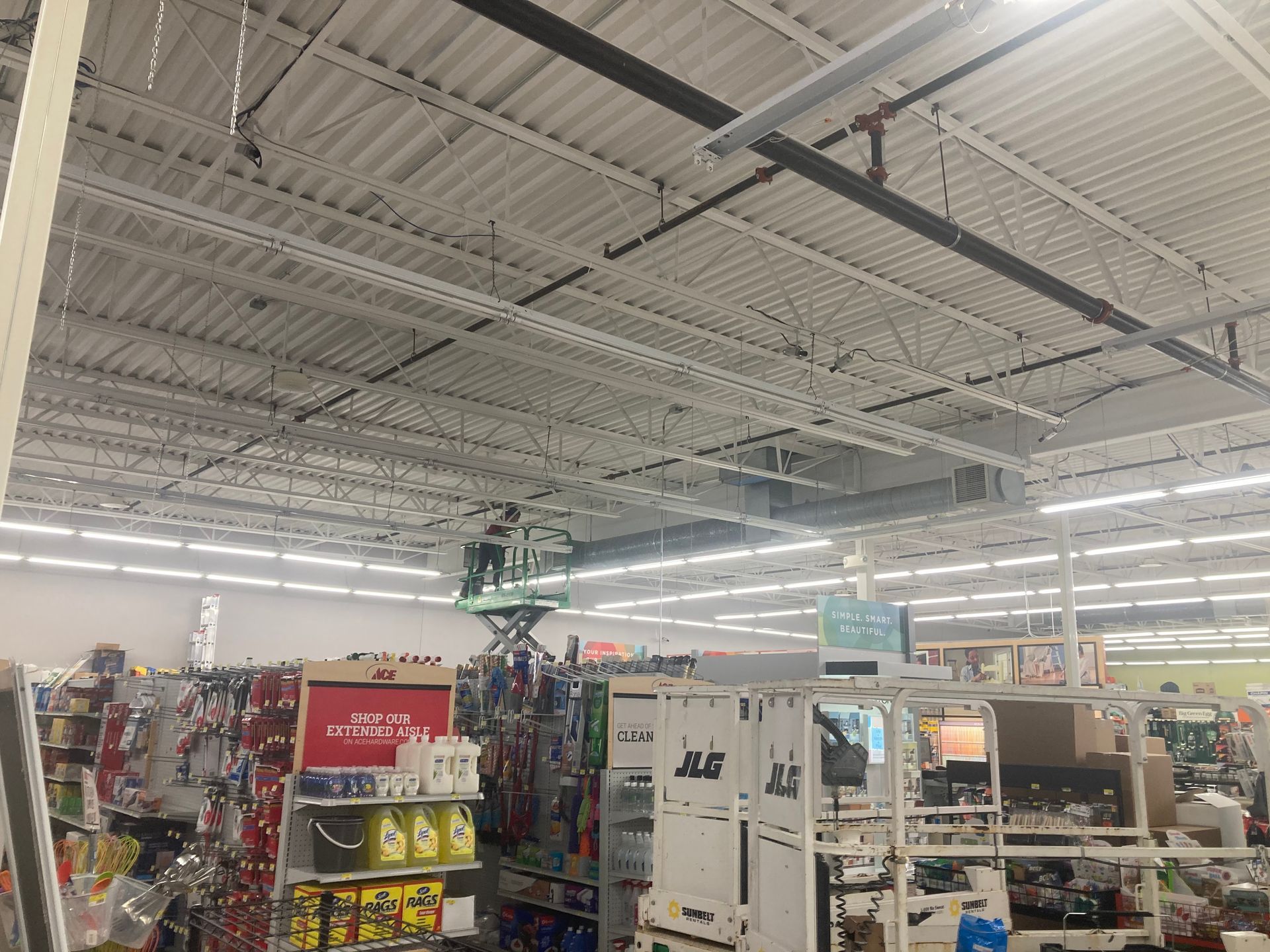 The inside of a store with a lot of shelves and a ceiling.