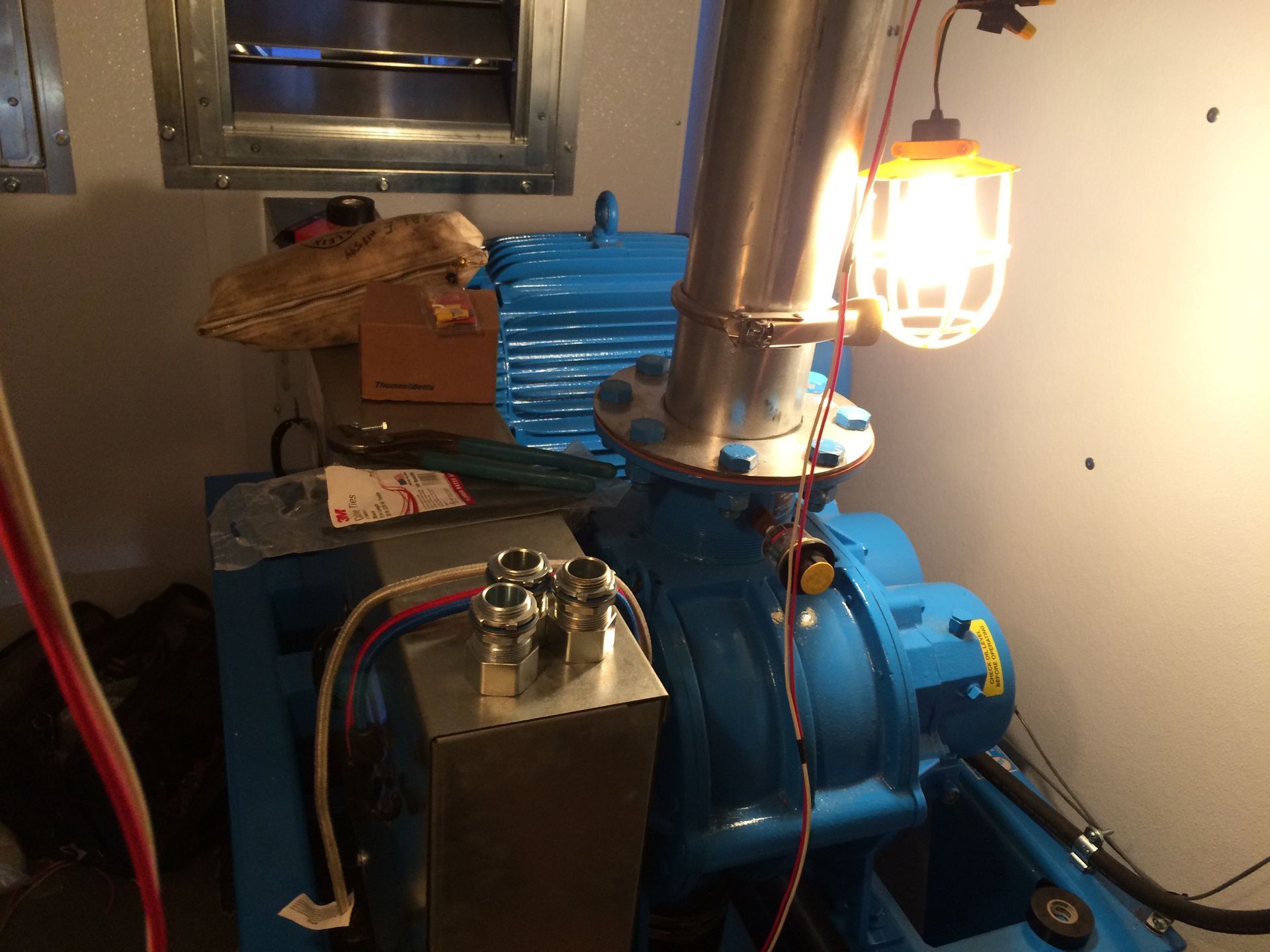 A blue machine with a light on top of it