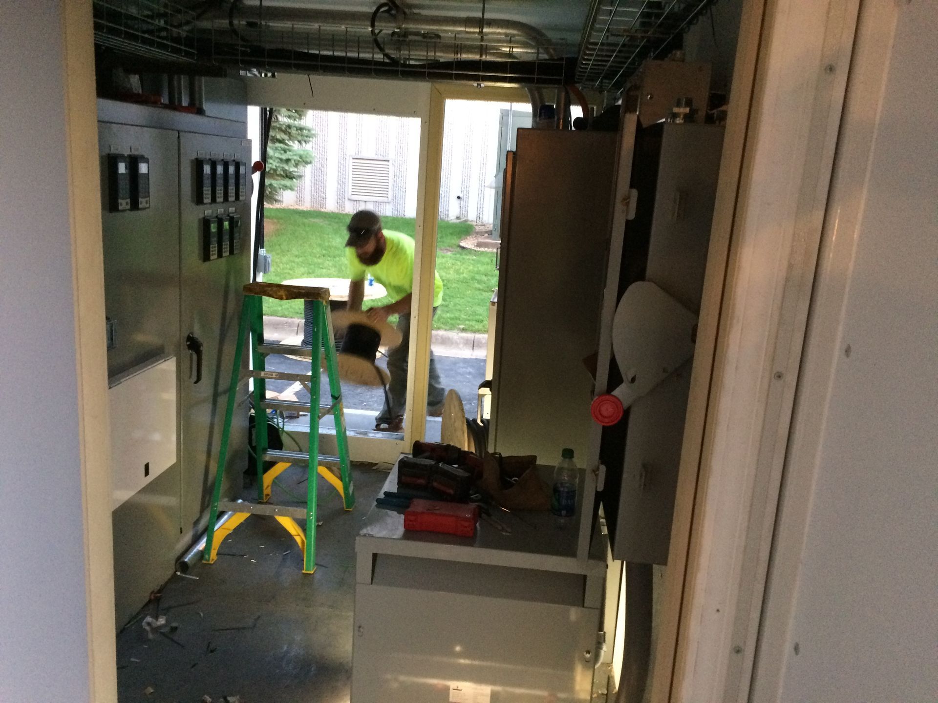 A man is standing on a ladder in a room.