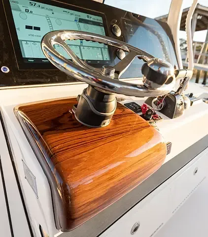 A close up of a steering wheel on a boat.