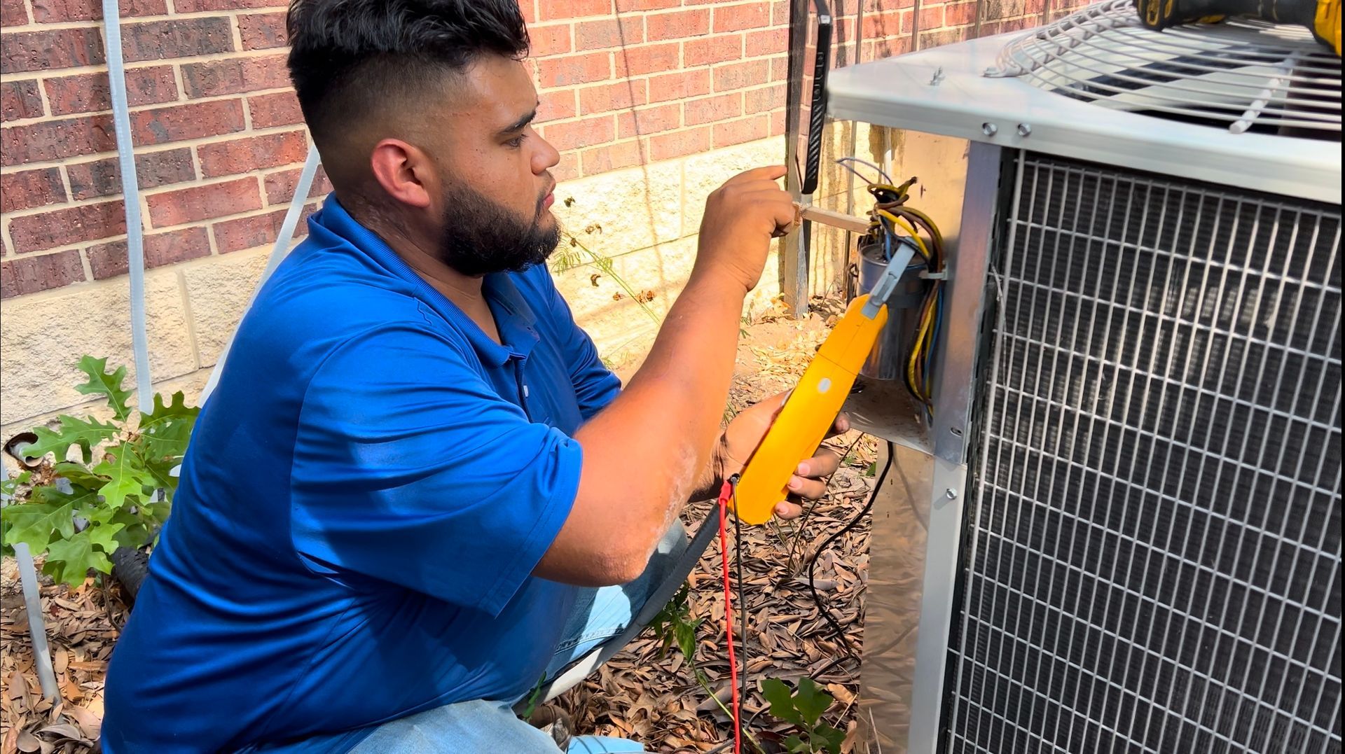 Man Repairing an Outdoor Air Conditioning Unit - Fort Worth, TX - A/C Kives Heating & Air Conditioning