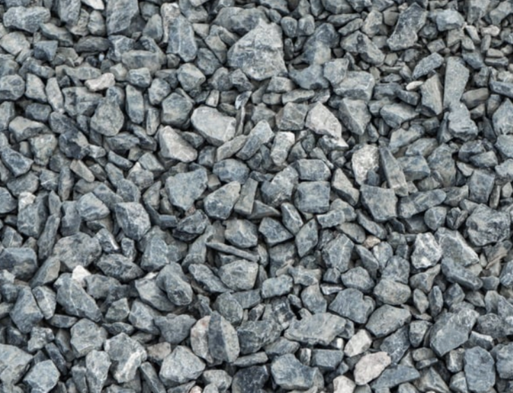 A pile of #57 stone gravel is sitting on the ground.