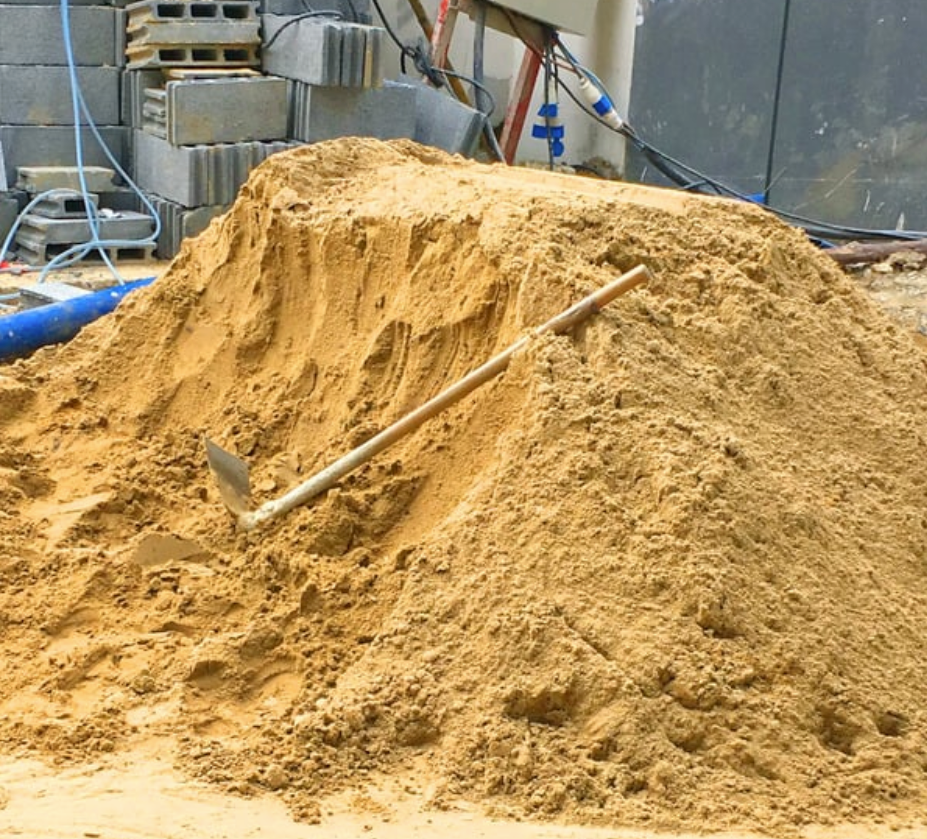 A pile of sand with a shovel in it