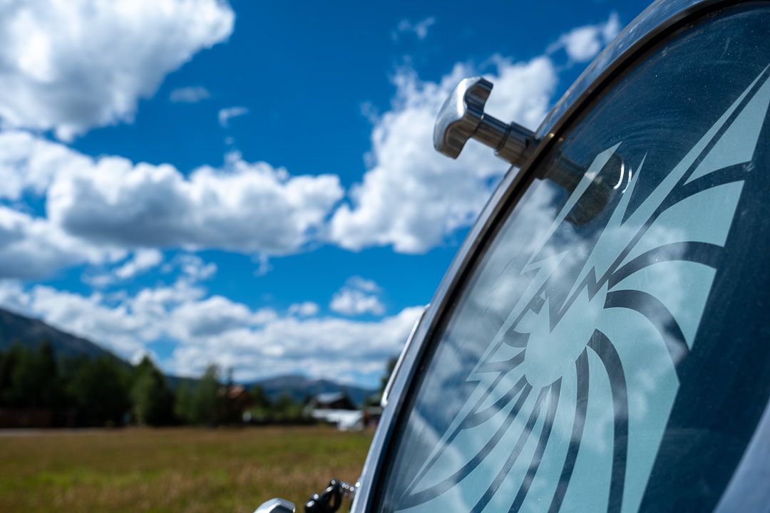 A close up of a car window with a swirl design on it