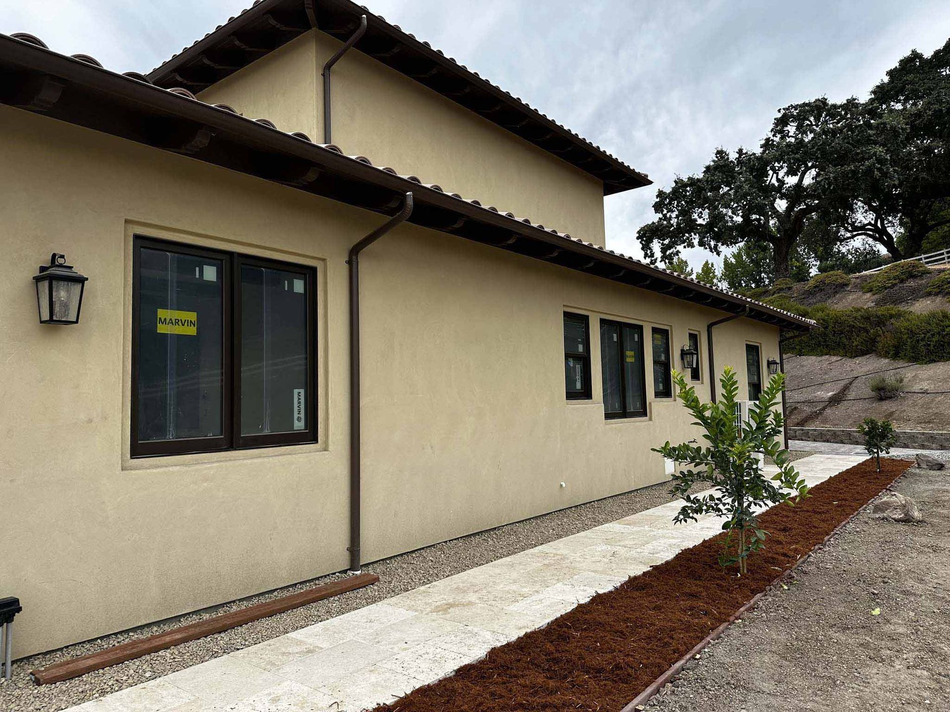 A house with a lot of windows and a walkway leading to it