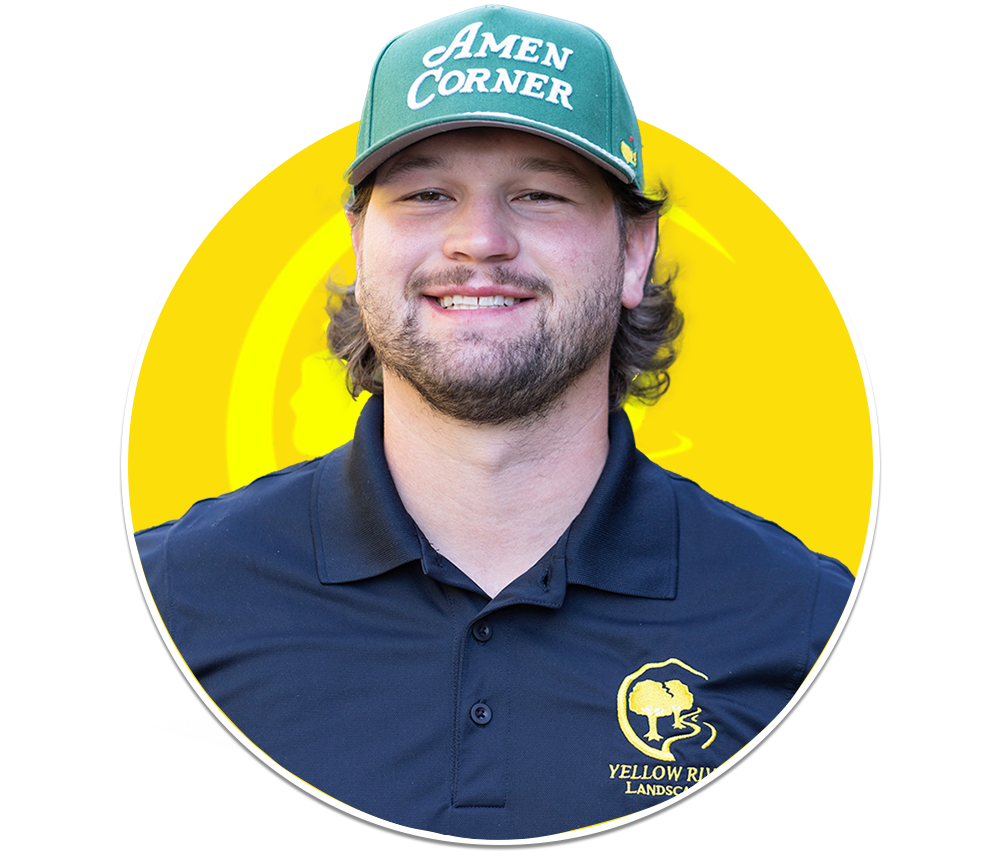 A smiling person wearing a green cap and a black polo.