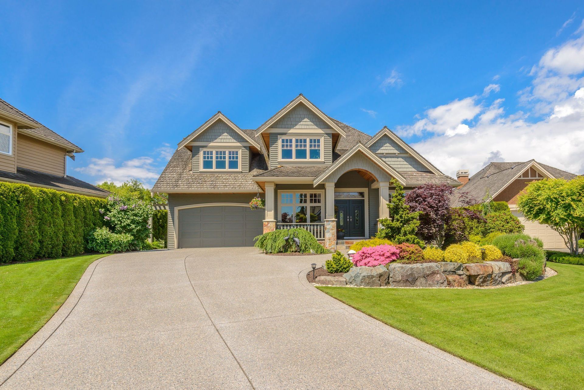 A large house with a concrete driveway leading to it.