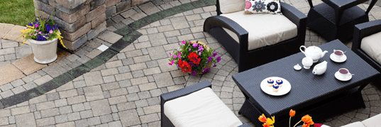 An aerial view of a patio with furniture and flowers.