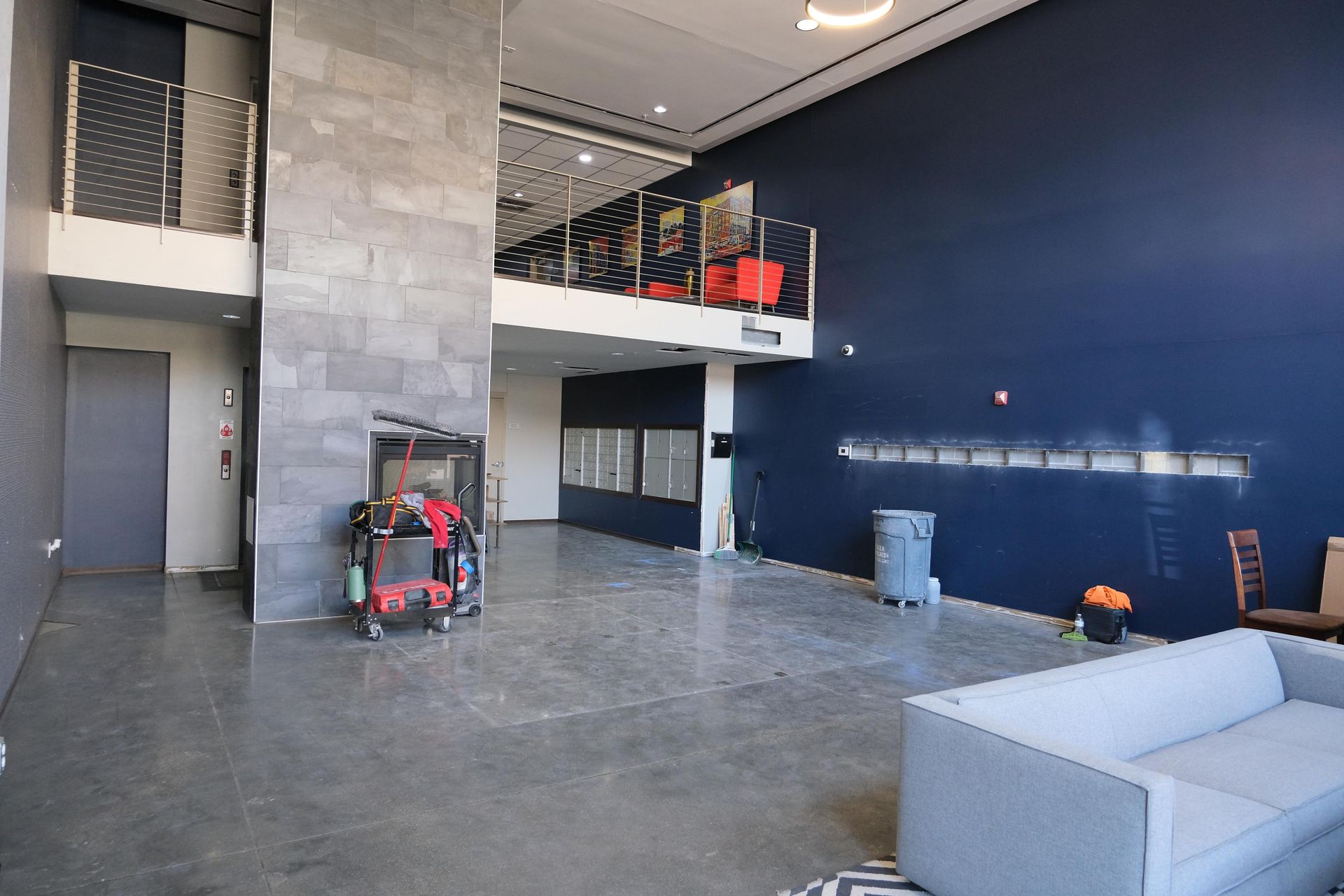 A large room with a couch and a blue wall