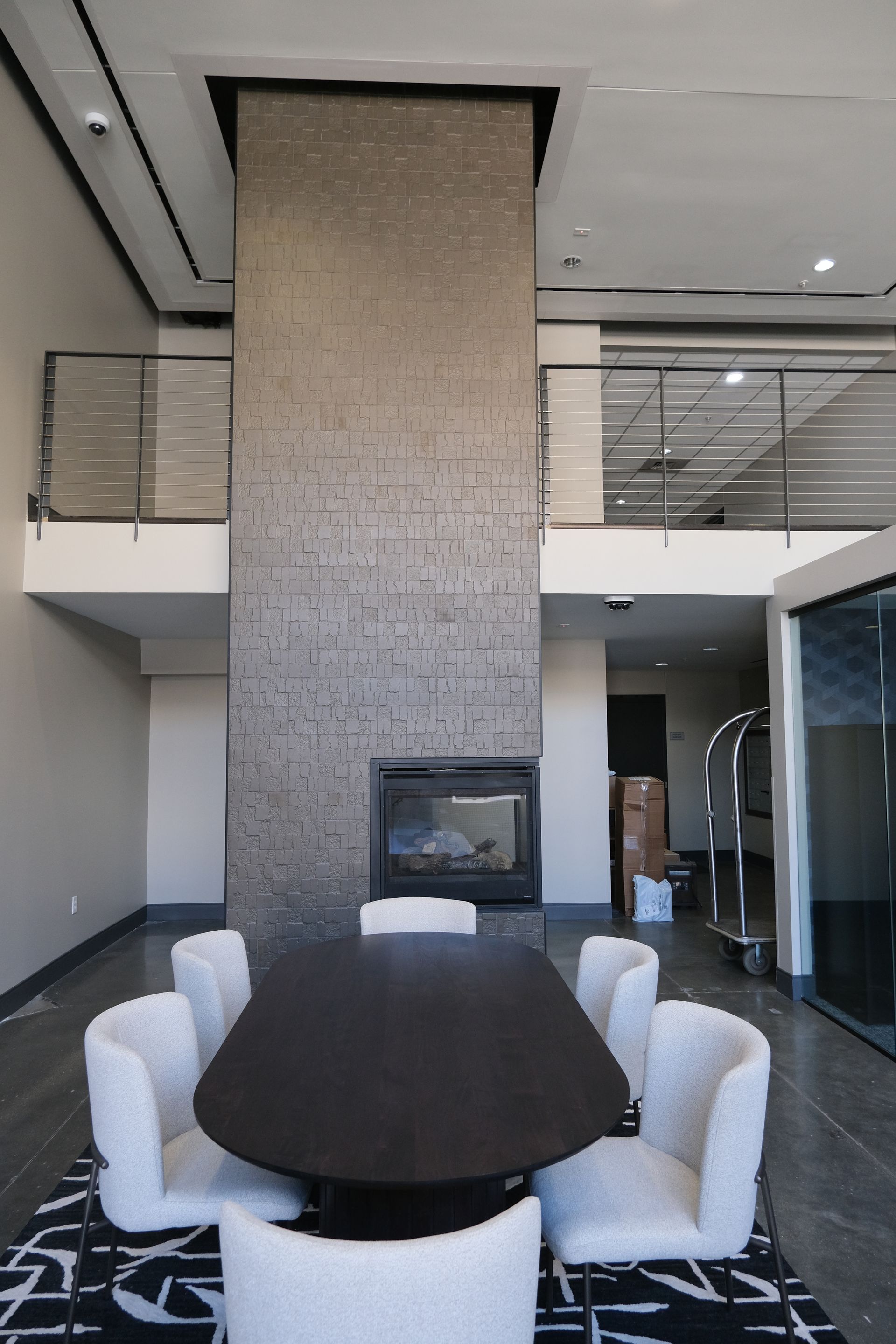 A dining room with a table and chairs and a fireplace