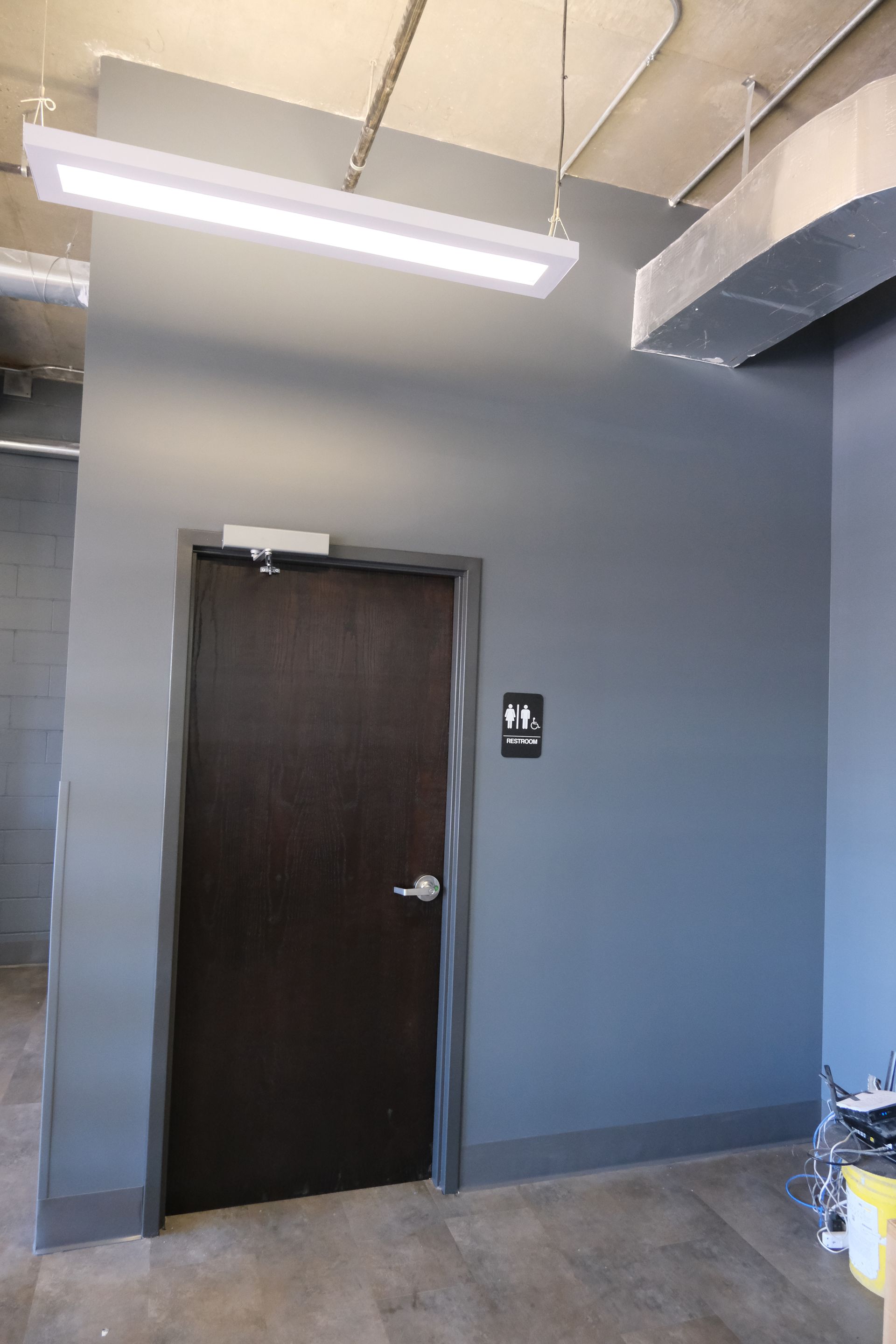 A room with a door and a light on the ceiling.
