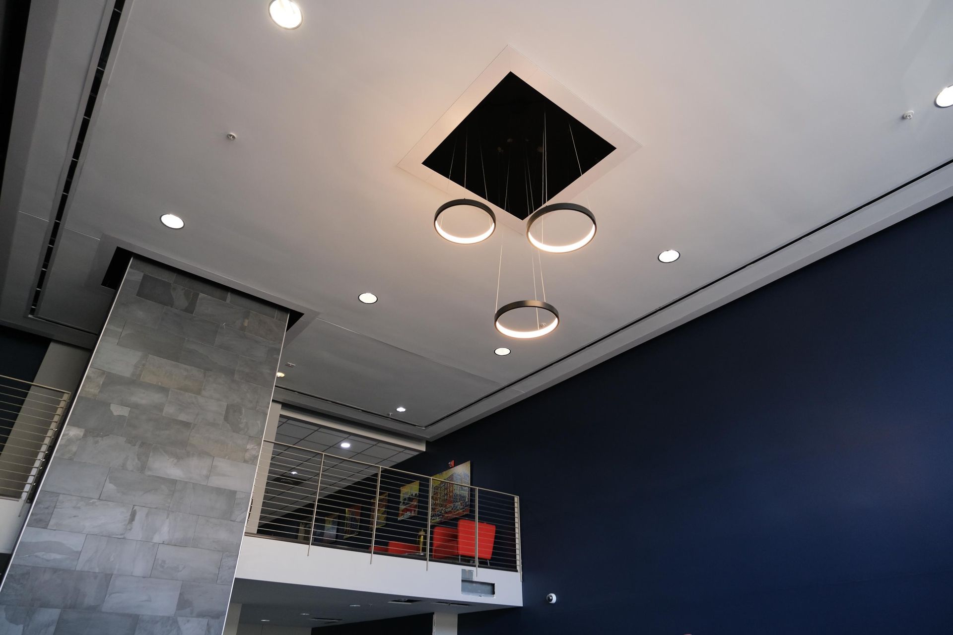 A ceiling with three rings hanging from it in a room.