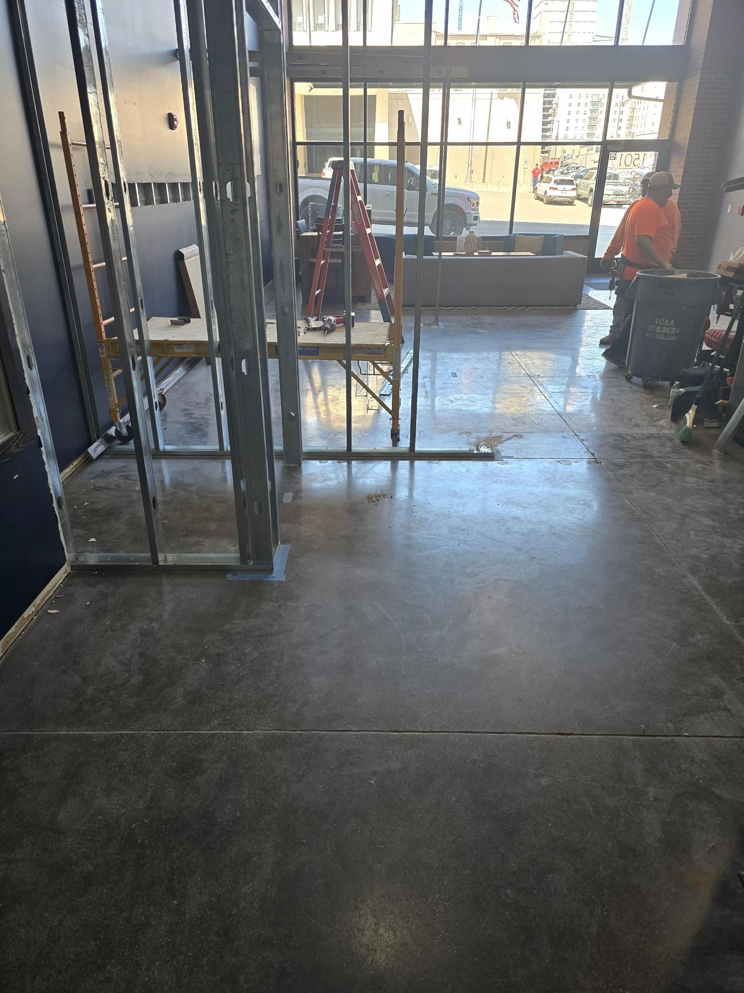 A building under construction with a concrete floor and a lot of windows.