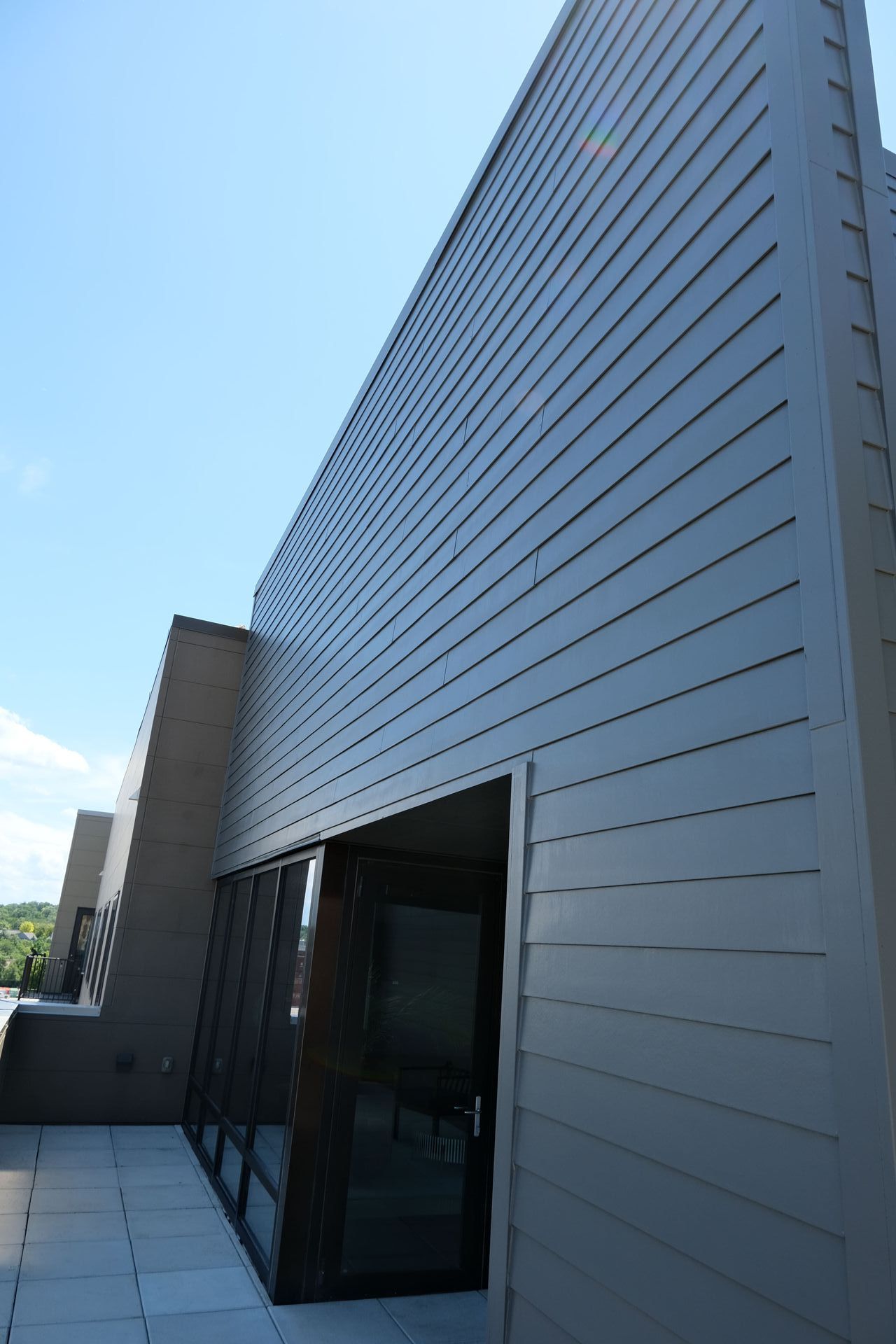 A large building with a lot of windows and a blue sky in the background