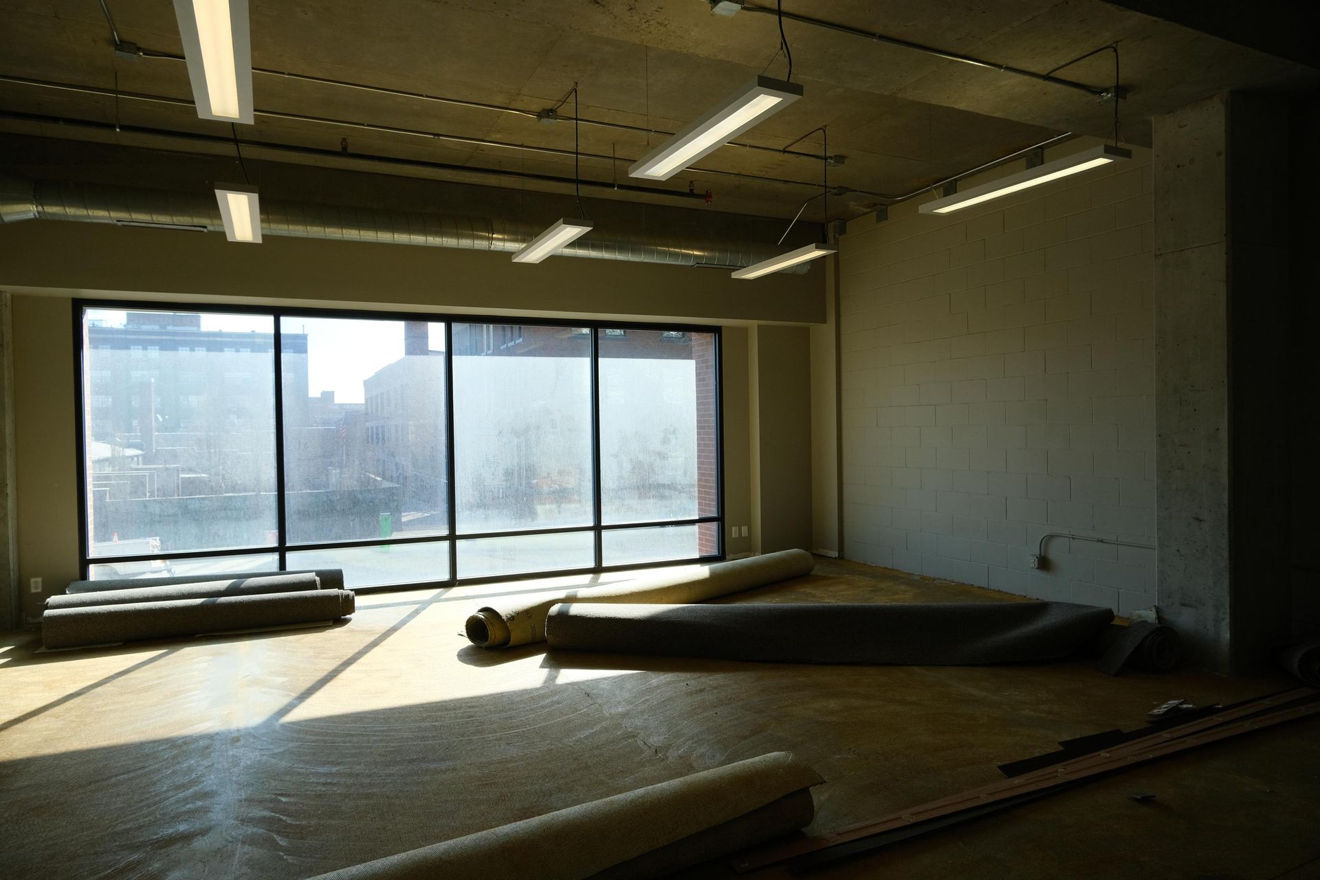 A large empty room with a lot of windows