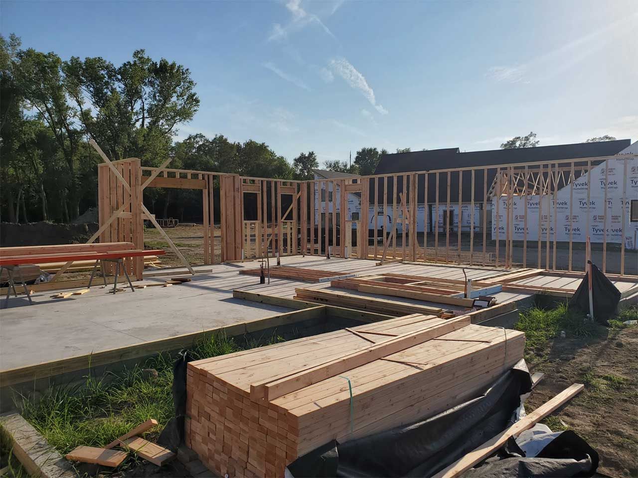 A house is being built with a lot of wood in the foreground