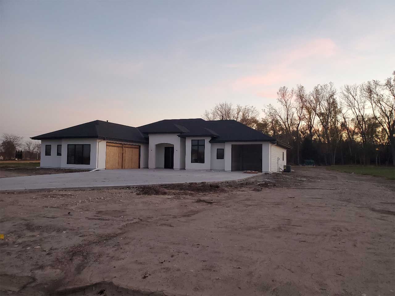 A house is being built in the middle of a dirt field
