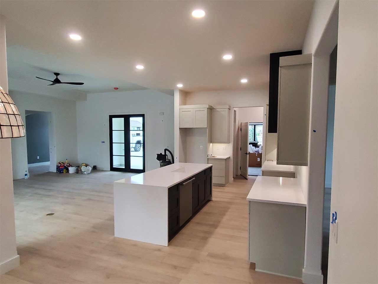 A kitchen with a large island and a ceiling fan